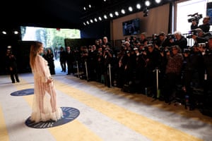 Olivia Wilde in a sheer dress posing for the press at the Vanity Fair Oscar Party Hosted By Radhika Jones at Wallis Annenberg Center for the Performing Arts in Beverly Hills