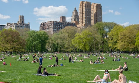 People gather in New York’s Central Park – some masked, others not.