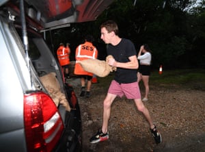 A man loads sandbags into his car in Murwillumbah, NSW