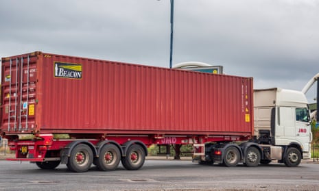 A lorry carrying a shipping container leaves the port of Liverpool. 