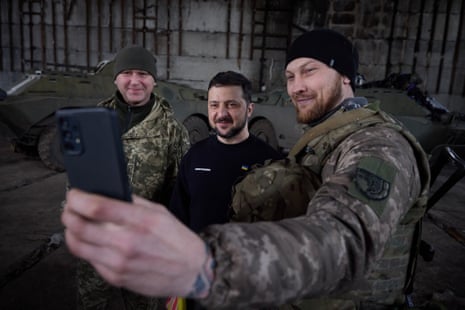 Zelenskiy poses for a photo with Ukrainian soldiers.