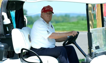 Donald Trump sitting in a golf cart