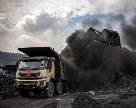 Coal is loaded into a truck at an open-cast mine near Dhanbad, eastern India