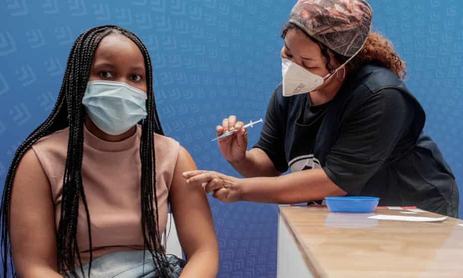 A woman receives a dose of a COVID-19 vaccine at a vaccine centre, in Sandton, Johannesburg.