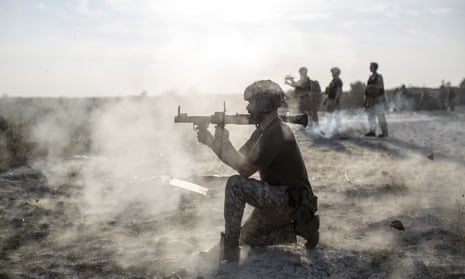 A Ukrainian soldier shoots a shoulder-grenade-launcher  during the military training.