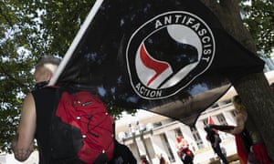 An anti-fascist protester holds a flag in Boston, Massachusetts, on 11 July.
