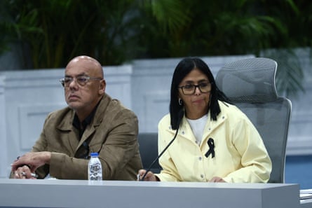 Delcy Rodríguez, in pale yellow shirt, speaks during a press conference alongside her national assembly president brother, Jorge, at an airbase in Caracas in July