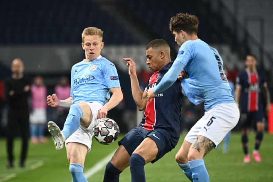 Kylian Mbappé is hustled off the ball by John Stones and Oleksandr Zinchenko. City restricted PSG to one set-piece goal in their two-leg tie.