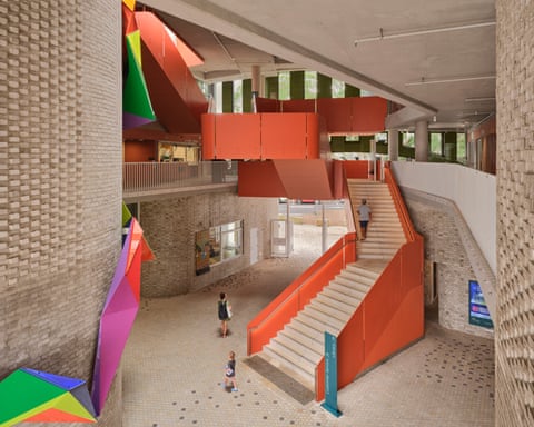 Concrete walls and colourful shapes, including a multi-story staircase.