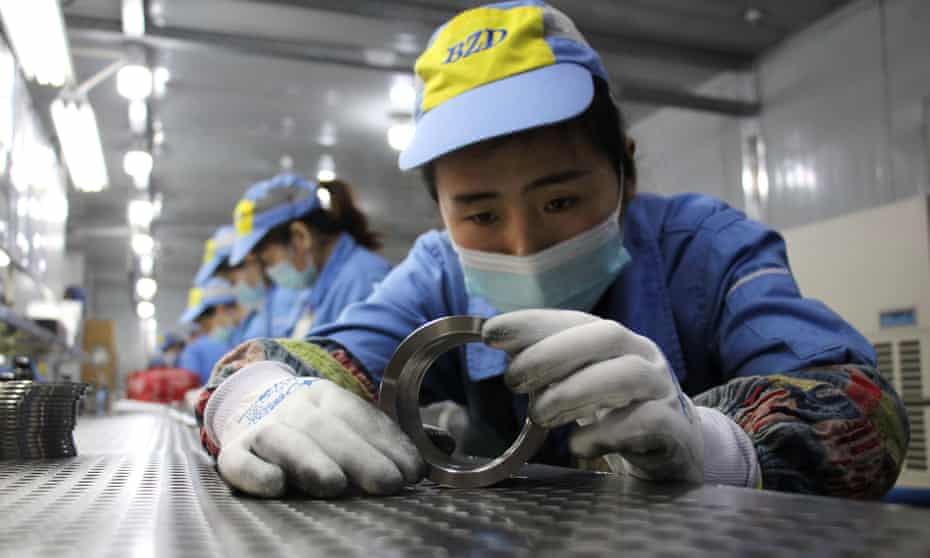 Workers checking aluminium pistons for vehicle engines at a factory in Binzhou, in China’s Shandong province