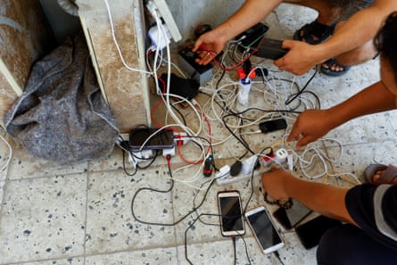 Charging phones from solar panels in Khan Younis, in the south of Gaza.
