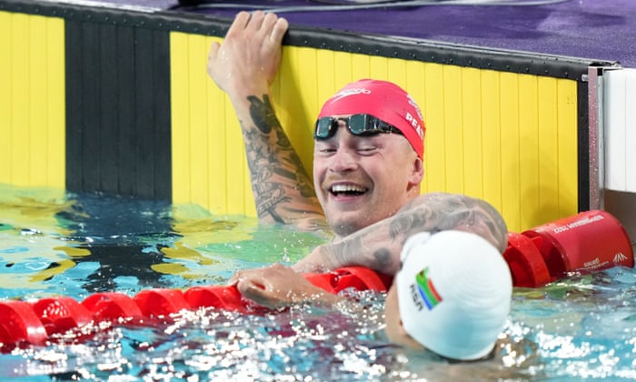 England's Adam Peaty and South Africa's Michael Houlie react after qualifying in their 50m breaststroke heat.