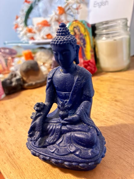 A small Buddha statuette on a table