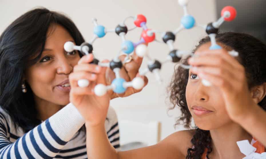 (Mother and daughter examining molecular model)