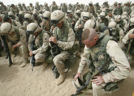 US Marines kneel and pray as the 2nd Battalion, 8th Regiment prepares to leave Camp Shoup, north of Kuwait City, in a northbound direction to start their advance into southern Iraq.