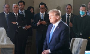 Vice-President Mike Pence and the treasury secretary, Steven Mnuchin, with phone, watch as Donald Trump participates in a live Fox News virtual town hall called ‘America Together: Returning to Work’.