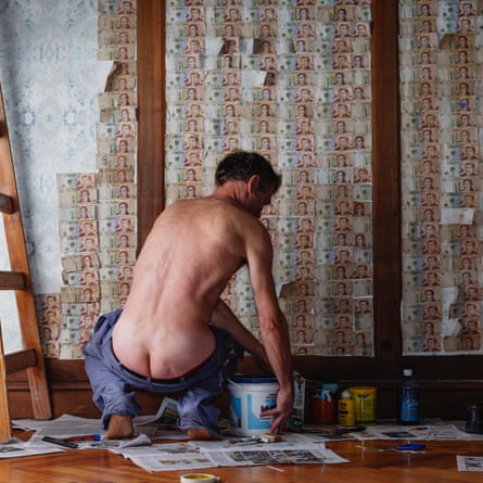 Werning photographed her husband wallpapering 10 pesos bills - which is cheaper than buying wallpaper.  Her husband's pants are deliberately worn low, 