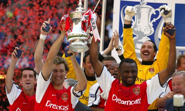 Adams and Patrick Vieira lift the FA Cup for Arsenal after victory over Chelsea in 2002. It was Adams’ 669th and last game for the Gunners.