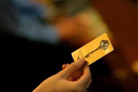 A manus holding a edifice cardinal card.