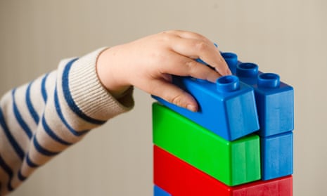 child playing with plastic building blocks
