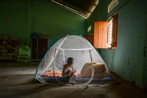 An ethnic Kuki child sits inside a tent at a relief camp for internally displaced people in the village of Litan, India.