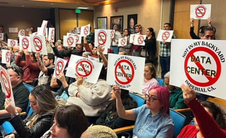 People hold up signs