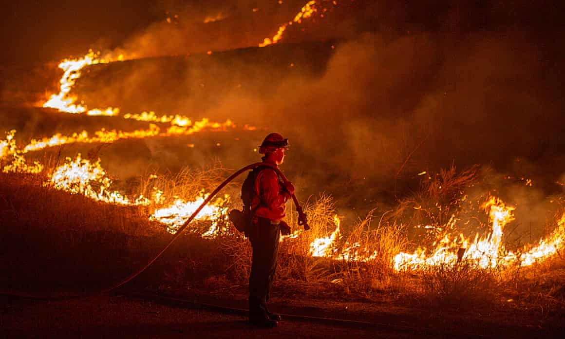 A firefighter working to contain the Hughes fire near Castaic Lake on Wednesday.