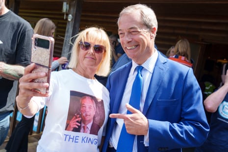 Nigel Farage poses for a photo with a supporter during a visit to Catton Hall in Frodsham, Cheshire, today.