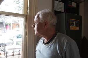 Michael Mobbs with his home’s inverter, which manages inputs from the solar panels and batteries.