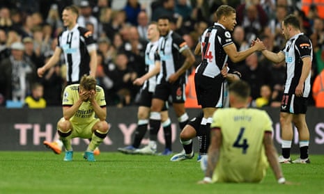 Arsenal’s Martin Odegaard (left) and Ben White sit amongst the celebrating Newcastle players after the final whistle.