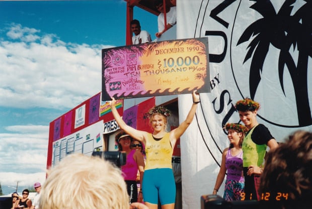 Pam Burridge on the podium holding up her winner's cheque.