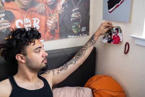A man touches a photo of himself as a child and his father