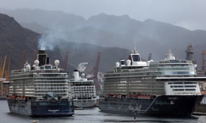 The TUI Cruises company ship ‘Mein Schiff 3’ (L) departures from the harbour of Santa Cruz de Tenerife, Canary Islands, Spain, 18 April 2020.Nearly 3,000 crew have been quarantined on board after one person tested positive for the novel coronavirus.