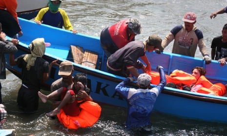 Rescuers assist survivors arriving in West Java in 2013 after an Australia-bound boat carrying asylum-seekers sank off the Indonesian coast, leaving at least nine dead.