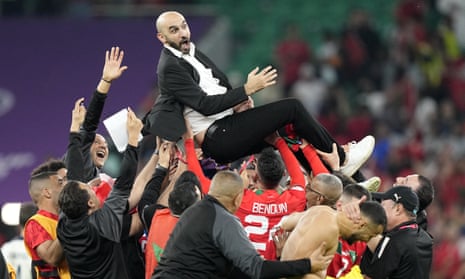 Morocco's head coach, Walid Regragui, is thrown into the air in celebration by players