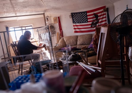 Drake Mace weaves a rug at his home using a vertical loom.