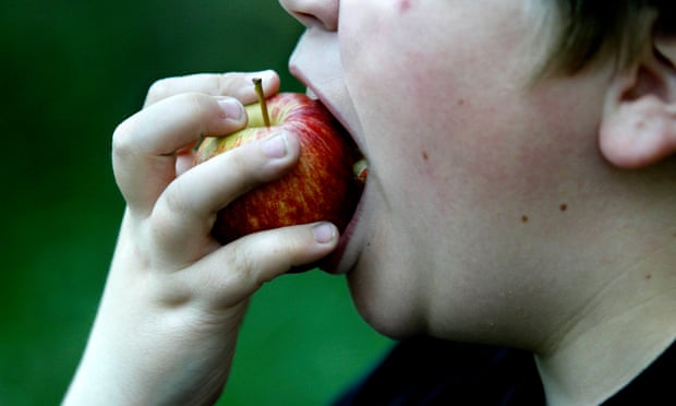 A boy eating an apple