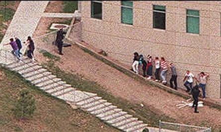Students flee Columbine high school in the middle of the shooting.