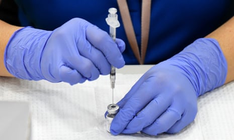 A nurse prepares a vaccine jab