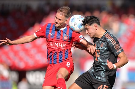 Léo Scienza and Aleksandar Pavlovic compete for the ball during the Bundesliga match between Heidenheim and Bayern Munich