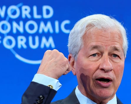 Jamie Dimon raises his fist while on stage at the Davos meeting