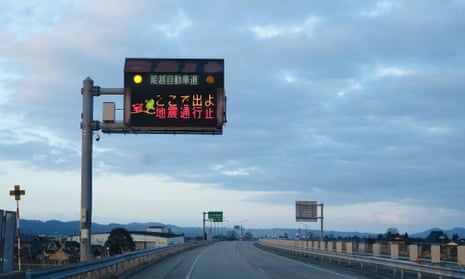 A road sign informs drivers to exit the expressway due to earthquakes in Oyabe city, Toyama prefecture.