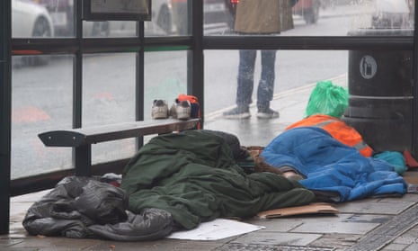 Two homeless men asleep in the bus shelter opposite Windsor Castle, 14 November 2022.
