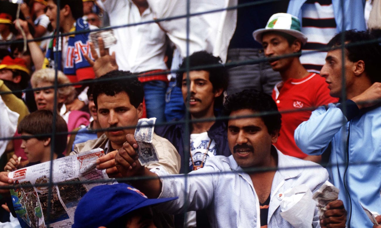 An Algerian fan waves a bank note showing their disgust at what they think is a fixed drawn match between the two teams West Germany v Austria World Cup 1982 played in Gijon.