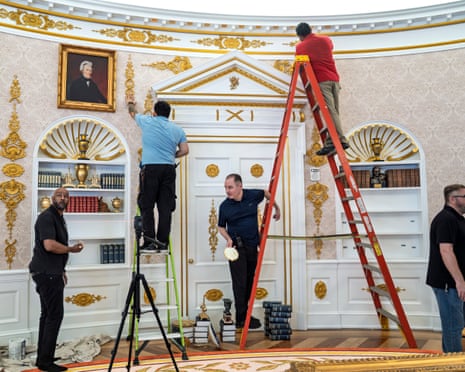 Men on ladders in a white and gold room.