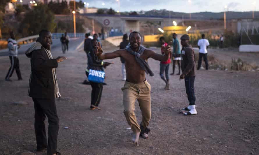 A migrant runs towards the temporary holding centre (CETI) after scaling Melilla’s border fence with Morocco.