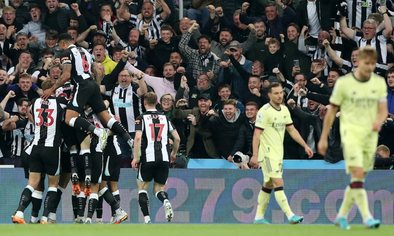 Newcastle players celebrate their first goal in front of a raucous crowd at St James’ Park.