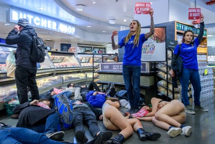 people on the ground with others holding signs