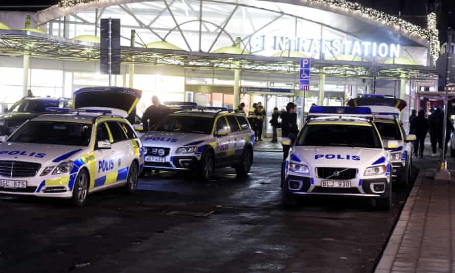 Swedish police arrive on the scene as masked men target refugees and migrants in Stockholm.