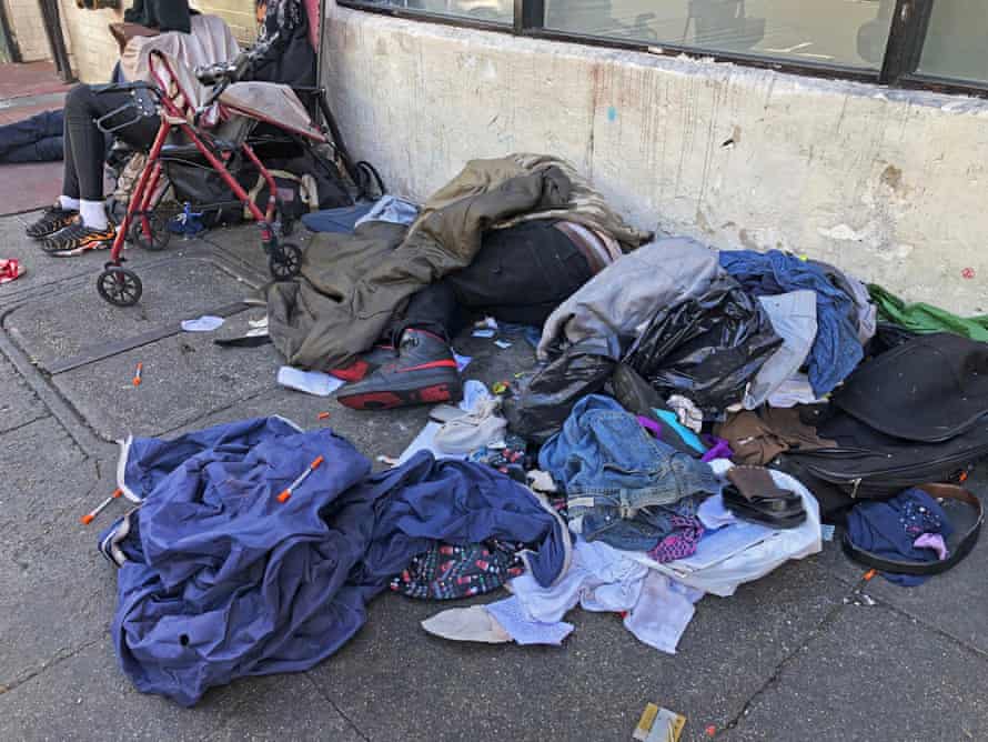 A street in San Francisco’s Tenderloin district is a jumble of sleeping people, discarded clothes and used needles.